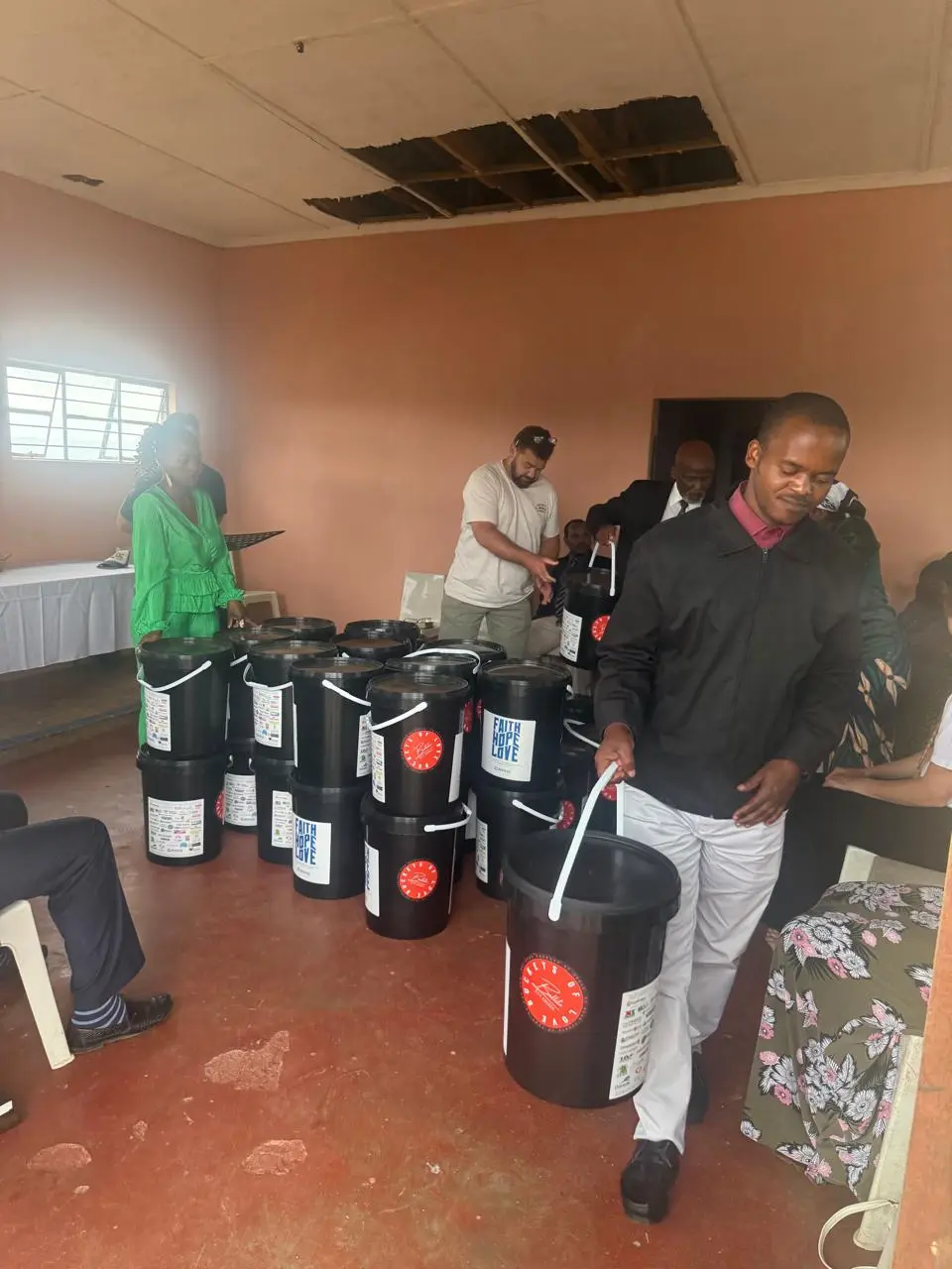 A bucket of food and everyday essentials being received