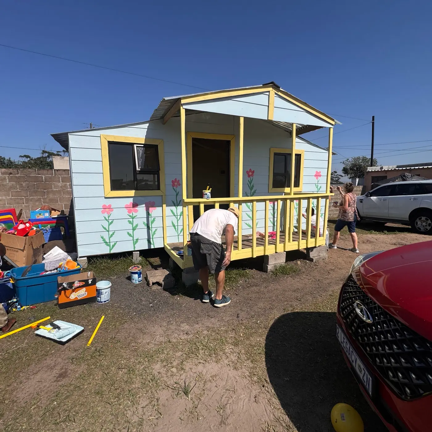 The painted cabin with the team still at work around it