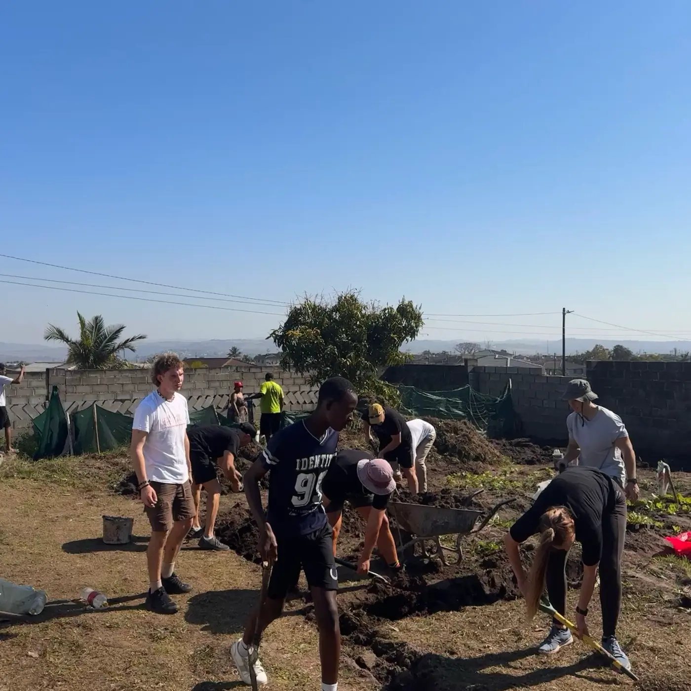 Volunteers clearing rubble and levelling the ground by hand