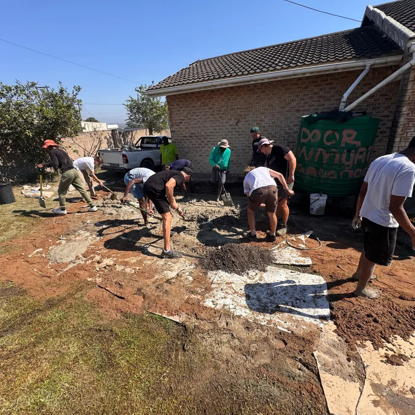 The team digging out the site beside the house