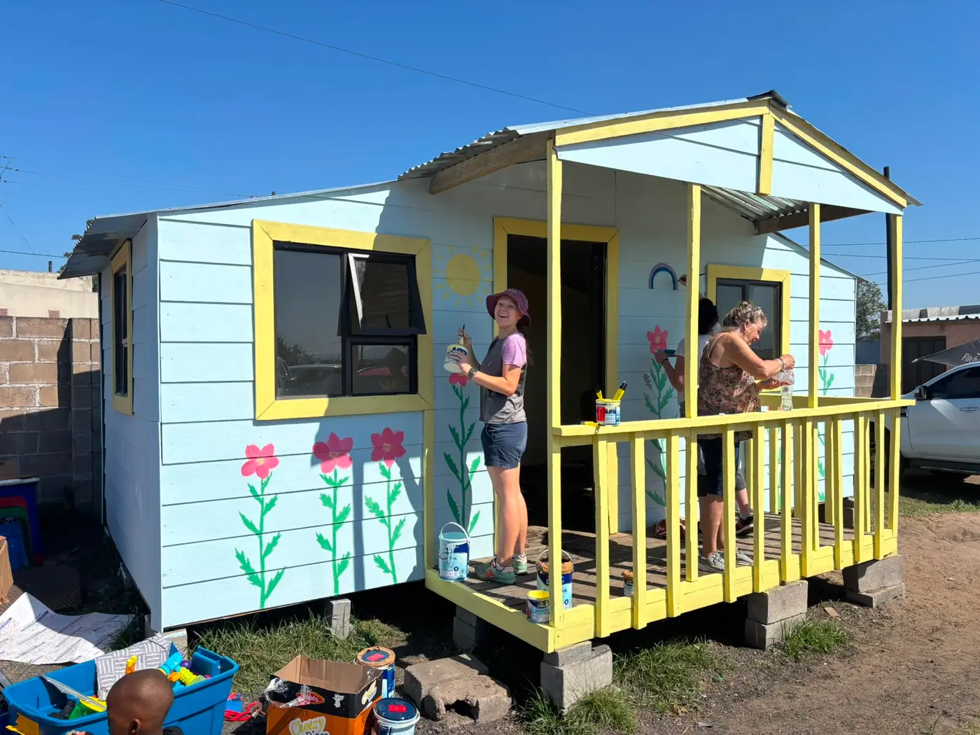 A volunteer on the porch of the finished cabin