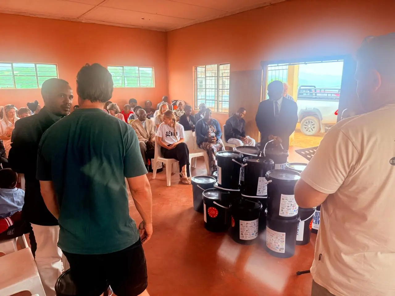The team with the community gathered in the hall at Glendale
